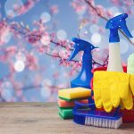 Spring cleaning concept with supplies over floral background