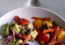 CHICKEN WINGS SERVED WITH PAN FRIED VEGES AND AVOCADO SALAD.
