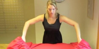 A woman shares a 30-second technique for folding fitted sheets