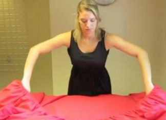 A woman shares a 30-second technique for folding fitted sheets
