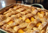 Sweet and Steamy: Hot Peach Cobbler Fresh from the Oven – A Timeless Treat!