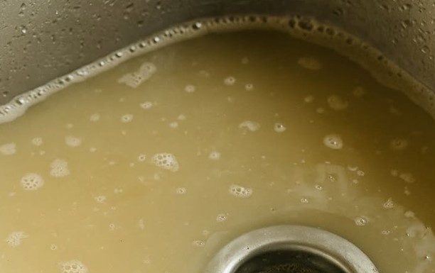 My kitchen sink takes forever to drain, and I’m hosting dinner soon — what can I safely try first?
