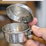 Found at a Yard Sale: This Small Silver Pan With a Hinged Lid and Thumb Trigger — What Is It?