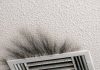 I keep cleaning these dark smudges around my air vent, but they keep coming back. It looks like soot or maybe black mold spreading across the ceiling. It’s the only vent in the house doing this. Is