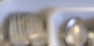 Small metal tool with a hooked, serrated end and a wooden handle. Found it mixed in with old silverware. Too sharp to be a spoon, too curved for a knife.