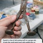 Found in a box of old sewing stuff at a garage sale. It looks like small metal tongs with padded discs at the end and a loop for a chain. What on earth is this thing used for?