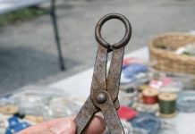 Found in a box of old sewing stuff at a garage sale. It looks like small metal tongs with padded discs at the end and a loop for a chain. What on earth is this thing used for?