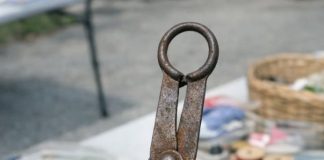Found in a box of old sewing stuff at a garage sale. It looks like small metal tongs with padded discs at the end and a loop for a chain. What on earth is this thing used for?