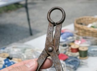 Found in a box of old sewing stuff at a garage sale. It looks like small metal tongs with padded discs at the end and a loop for a chain. What on earth is this thing used for?