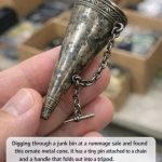 Digging through a junk bin at a rummage sale and found this ornate metal cone. It has a tiny pin attached to a chain and a handle that folds out into a tripod. What in the world is this thing?
