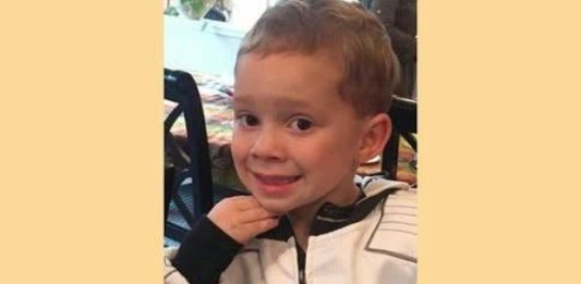 Two little boys were at sitting together in a church